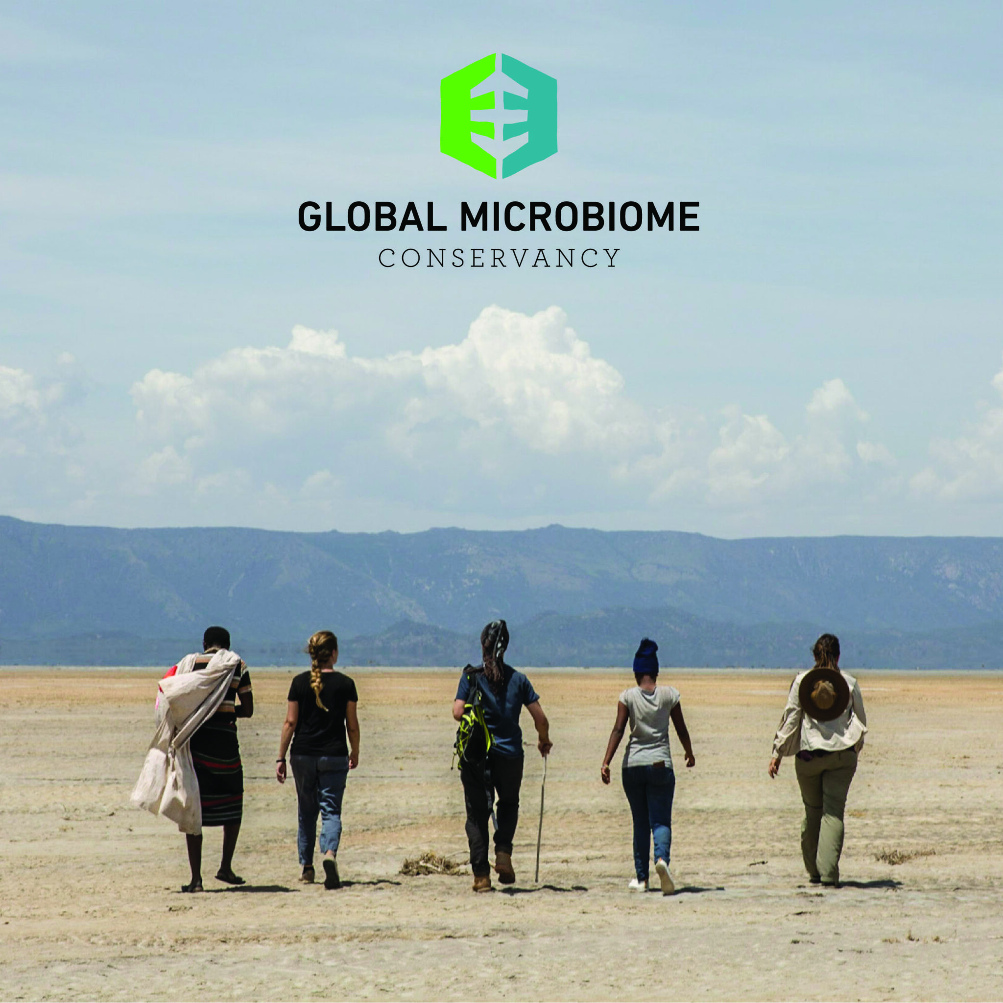 A group of 5 scientists walking through a dried river bed.